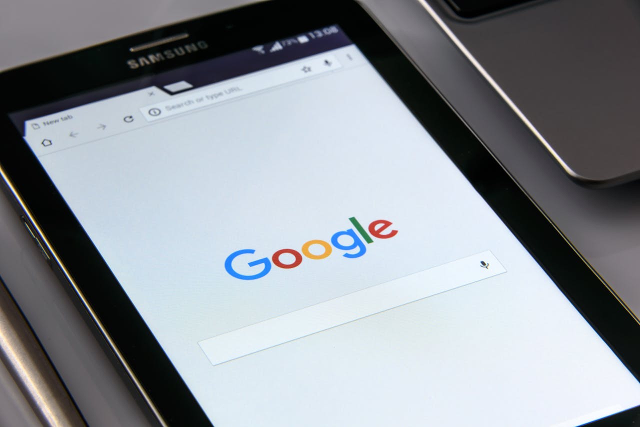 services-01 Close-up of a tablet displaying Google's search screen, emphasizing technology and internet browsing.